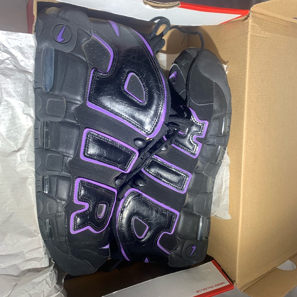 These are Nike Air More Uptempo '96 sneakers in the Black/Action Grape colorway.